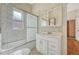Bright bathroom with a shower-tub combo, a white vanity with a sink, and a medicine cabinet at 2421 W 38Th Ave, Denver, CO 80211