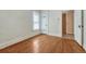 Bedroom with hardwood floors, white walls, trim and access to another room at 2421 W 38Th Ave, Denver, CO 80211