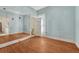 Bedroom showcasing hardwood floors, and light blue walls with a large mirror, and natural light at 2421 W 38Th Ave, Denver, CO 80211