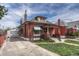 Charming brick home with a well-maintained lawn, driveway, and detached garage at 2421 W 38Th Ave, Denver, CO 80211