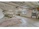 Spacious garage featuring concrete floor, large workbench area, window for natural light, and ample storage space at 2421 W 38Th Ave, Denver, CO 80211