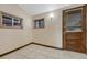 Small room with a wooden door, window and tiled floor at 2421 W 38Th Ave, Denver, CO 80211