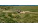 Aerial view of house and land, surrounded by green fields and dirt roads at 29333 Rawhide Ct, Elizabeth, CO 80107