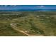 High aerial view of the property showcasing the house, surrounding fields, and distant mountains at 29333 Rawhide Ct, Elizabeth, CO 80107
