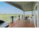 Back deck with wood flooring, outdoor seating, and stunning views of the green landscape at 29333 Rawhide Ct, Elizabeth, CO 80107