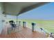 Relaxing back deck featuring outdoor seating, beautiful green views, and wooden flooring at 29333 Rawhide Ct, Elizabeth, CO 80107