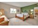 Bedroom boasts a large window, a wooden bed frame, and an accent wall at 29333 Rawhide Ct, Elizabeth, CO 80107