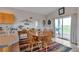 Bright dining area features tile floors, a wooden table, and sliding glass doors to an outdoor deck at 29333 Rawhide Ct, Elizabeth, CO 80107
