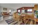 Open-concept dining area connected to the living room and kitchen, featuring a wooden table and chairs at 29333 Rawhide Ct, Elizabeth, CO 80107
