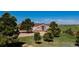 Inviting home with a welcoming porch surrounded by mature trees in a serene, natural setting at 29333 Rawhide Ct, Elizabeth, CO 80107