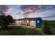 Beautiful home with a cozy front porch, set against a backdrop of a vivid, colorful sunset at 29333 Rawhide Ct, Elizabeth, CO 80107