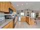Stylish kitchen with wood cabinets, granite countertops, and modern stainless steel appliances at 29333 Rawhide Ct, Elizabeth, CO 80107