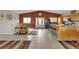 Bright living room featuring tile floors, a seating area, and kitchen with a breakfast bar at 29333 Rawhide Ct, Elizabeth, CO 80107