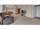 Spacious living room with ceiling fan, leather seating, and an entertainment center for comfortable relaxation at 29333 Rawhide Ct, Elizabeth, CO 80107