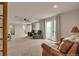 Open living room with neutral walls, sliding doors and comfortable leather seating at 29333 Rawhide Ct, Elizabeth, CO 80107