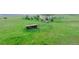 Wide shot of acreage with barn and fence, showing a pastoral country property with light green grass and rolling hill at 29333 Rawhide Ct, Elizabeth, CO 80107