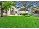 This home's backyard features a manicured lawn, mature trees, and a patio at 3151 E 134Th Cir, Thornton, CO 80241