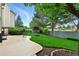 This home's backyard features a green lawn, mature trees, and a covered patio at 3151 E 134Th Cir, Thornton, CO 80241