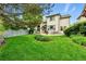This home's backyard features a manicured lawn, mature trees, and a patio at 3151 E 134Th Cir, Thornton, CO 80241