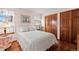 Cozy bedroom with natural light, hardwood floor, closet, and side table at 3151 E 134Th Cir, Thornton, CO 80241