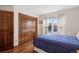 Comfortable bedroom featuring hardwood floors, natural light, and spacious closet at 3151 E 134Th Cir, Thornton, CO 80241