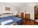 Bedroom with wood floors, natural light, desk, and convenient bathroom access at 3151 E 134Th Cir, Thornton, CO 80241