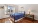 Cozy bedroom with hardwood floors, ample natural light, and side table with lamp at 3151 E 134Th Cir, Thornton, CO 80241