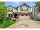 Charming two-story home with brick accents, a two-car garage, and mature landscaping at 3151 E 134Th Cir, Thornton, CO 80241