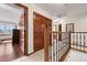 Second floor hallway with tile floor, wood banister and views to the exterior at 3151 E 134Th Cir, Thornton, CO 80241