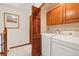 Laundry room includes tile floor, washer, dryer, cabinets, and a closet at 3151 E 134Th Cir, Thornton, CO 80241