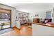 Cozy living room with large window offering natural light and warm hardwood floors at 3151 E 134Th Cir, Thornton, CO 80241