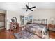 Bright main bedroom boasts wood floors, ceiling fan, ensuite bathroom, and vanity area at 3151 E 134Th Cir, Thornton, CO 80241