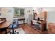 This home office features a large window providing natural light and a wood desk with storage at 3151 E 134Th Cir, Thornton, CO 80241