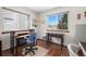This home office features a large window providing natural light and a wood desk at 3151 E 134Th Cir, Thornton, CO 80241