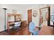 This home office features a wood desk with storage and a hard wood floor at 3151 E 134Th Cir, Thornton, CO 80241