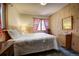 Comfortable bedroom featuring wood-paneled walls, and a queen bed at 10042 Buena Vista Dr, Conifer, CO 80433