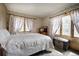 Bright bedroom with floral wallpaper, natural light, and vintage furnishings at 10042 Buena Vista Dr, Conifer, CO 80433