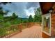 View from a large wooden deck with sturdy wood railings with mountain views at 10042 Buena Vista Dr, Conifer, CO 80433
