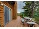 Spacious wooden deck with a table and benches overlooking a picturesque mountain view at 10042 Buena Vista Dr, Conifer, CO 80433