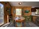 Charming dining area with wood paneled walls and a view of the outdoors at 10042 Buena Vista Dr, Conifer, CO 80433