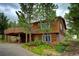 Charming cabin with a wooden exterior, inviting deck, and scenic views of the surrounding landscape at 10042 Buena Vista Dr, Conifer, CO 80433