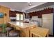 Open kitchen with vintage appliances, bar-stool seating, and view of outdoors at 10042 Buena Vista Dr, Conifer, CO 80433