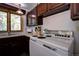 Vintage kitchen features dark wood cabinets, laminate countertops, and stainless steel appliances at 10042 Buena Vista Dr, Conifer, CO 80433