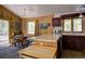 Eat-in kitchen with vintage appliances, wood paneled walls, and view of outdoors at 10042 Buena Vista Dr, Conifer, CO 80433