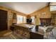 Comfortable living room with wood paneled walls, large windows, fireplace, and cozy seating at 10042 Buena Vista Dr, Conifer, CO 80433