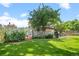 Lovely backyard with mature tree, covered patio and manicured lawn at 4161 W Lake Cir, Littleton, CO 80123