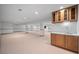 Large basement with wood cabinets and sink with space for entertaining at 4161 W Lake Cir, Littleton, CO 80123