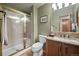 Bathroom featuring a walk-in shower with glass door and vanity with granite countertop at 4161 W Lake Cir, Littleton, CO 80123