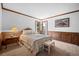 Cozy bedroom with wood trim, wainscoting, and a large window with natural light at 4161 W Lake Cir, Littleton, CO 80123