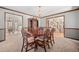 Traditional dining room with classic wood trim, elegant chandelier, and large window at 4161 W Lake Cir, Littleton, CO 80123